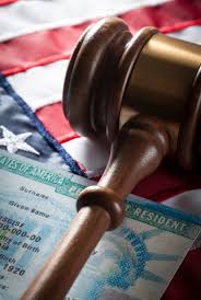 Gavel atop a green card