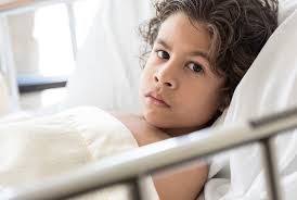 Child laying in hospital bed