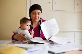 Mother holding child and sorting through immigration paperwork