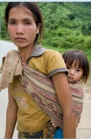 Mother with child strapped to her back